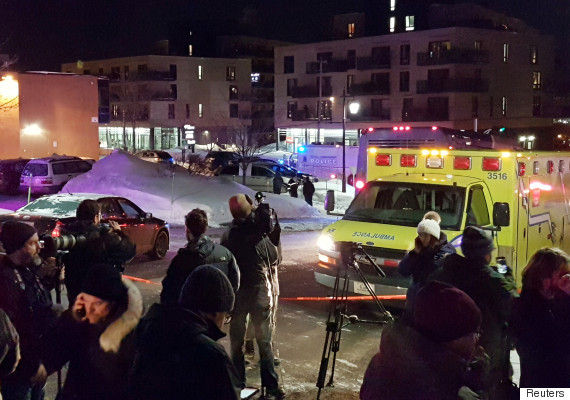 An ambulance is parked at the scene of a fatal shooting at the Quebec Islamic Cultural Centre in Quebec City